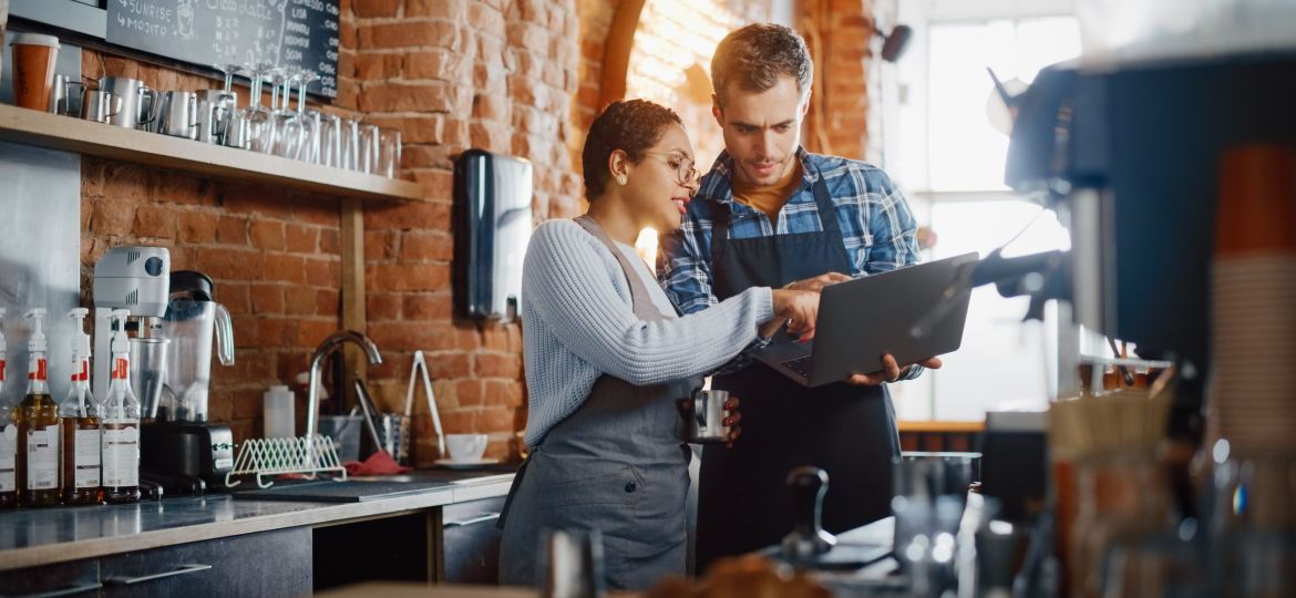 restaurant owners examining a computer